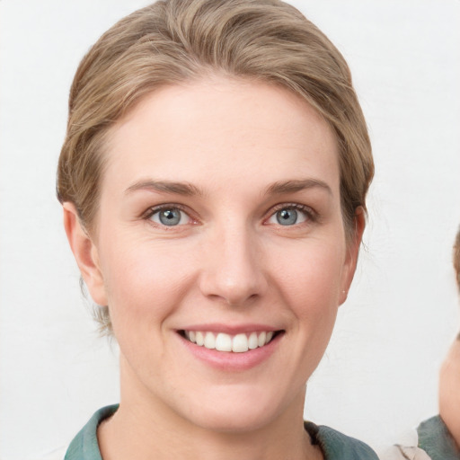 Joyful white young-adult female with medium  brown hair and blue eyes