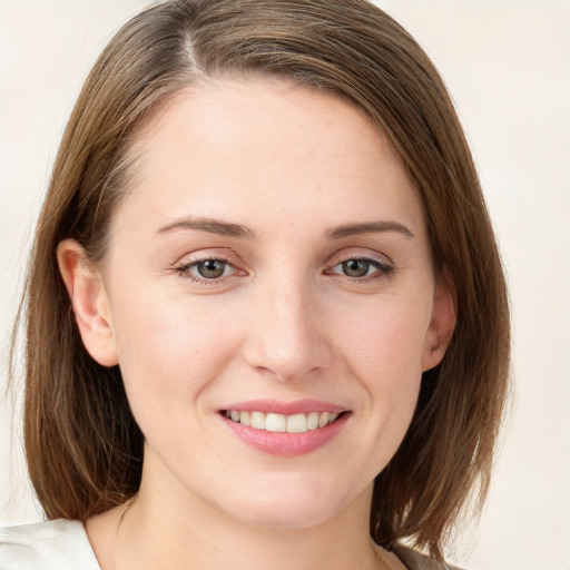 Joyful white young-adult female with medium  brown hair and blue eyes