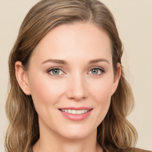 Joyful white young-adult female with long  brown hair and green eyes