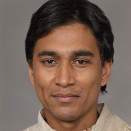 Joyful latino adult male with short  black hair and brown eyes