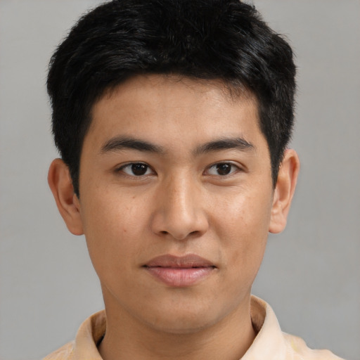 Joyful asian young-adult male with short  brown hair and brown eyes
