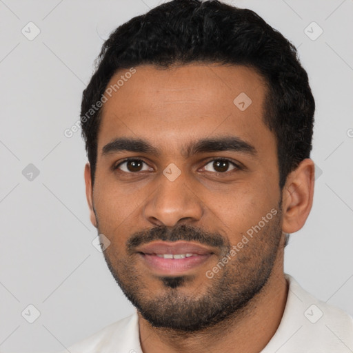 Joyful latino young-adult male with short  black hair and brown eyes