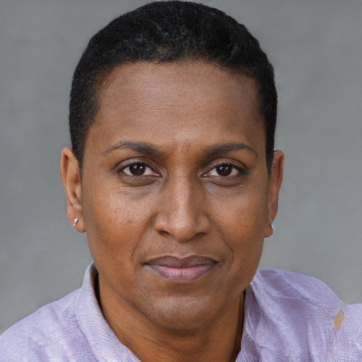 Joyful black adult female with short  brown hair and brown eyes