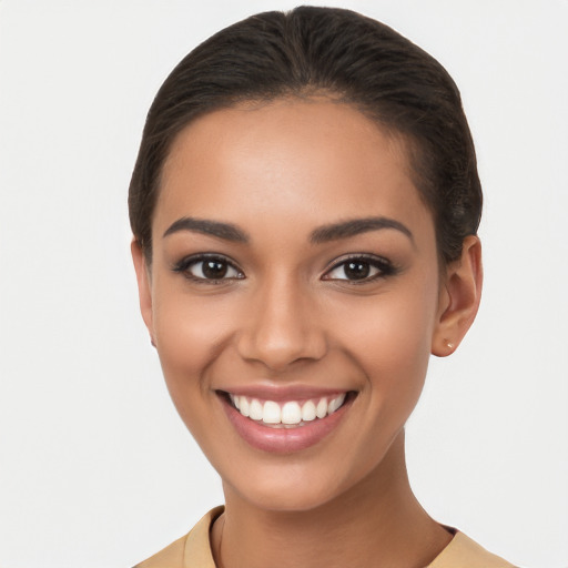 Joyful latino young-adult female with short  brown hair and brown eyes