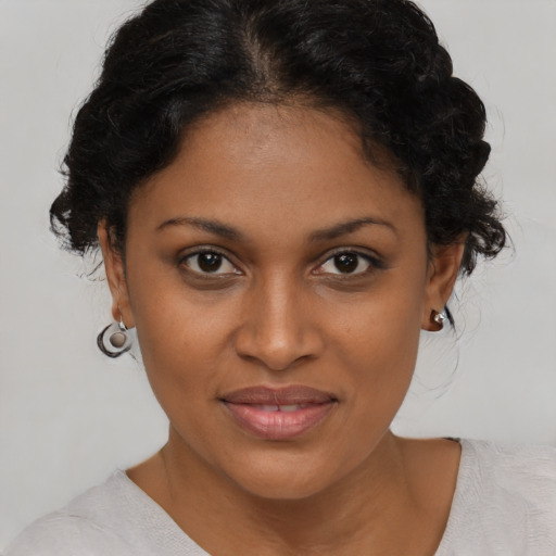 Joyful black young-adult female with medium  brown hair and brown eyes