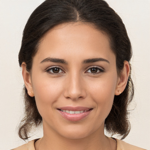 Joyful white young-adult female with long  brown hair and brown eyes