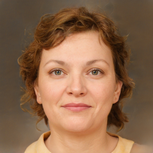 Joyful white young-adult female with medium  brown hair and green eyes