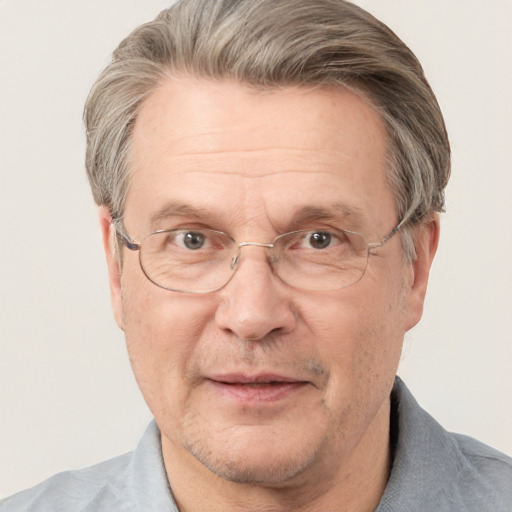 Joyful white middle-aged male with short  gray hair and blue eyes