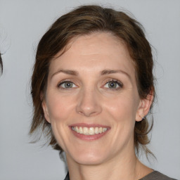 Joyful white young-adult female with medium  brown hair and brown eyes