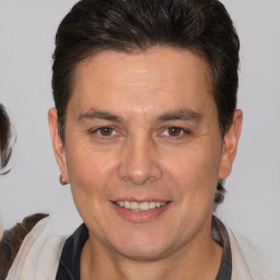 Joyful white adult male with medium  brown hair and brown eyes