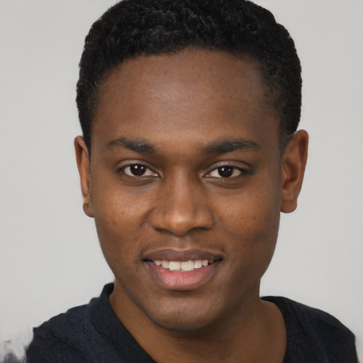 Joyful black young-adult male with short  brown hair and brown eyes
