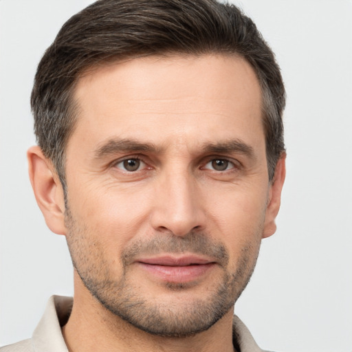 Joyful white adult male with short  brown hair and brown eyes