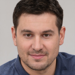 Joyful white young-adult male with short  brown hair and brown eyes