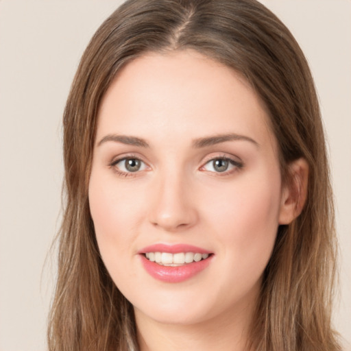 Joyful white young-adult female with long  brown hair and green eyes