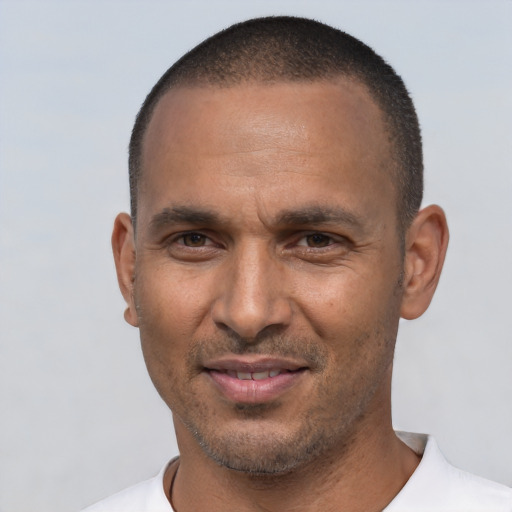 Joyful white adult male with short  black hair and brown eyes