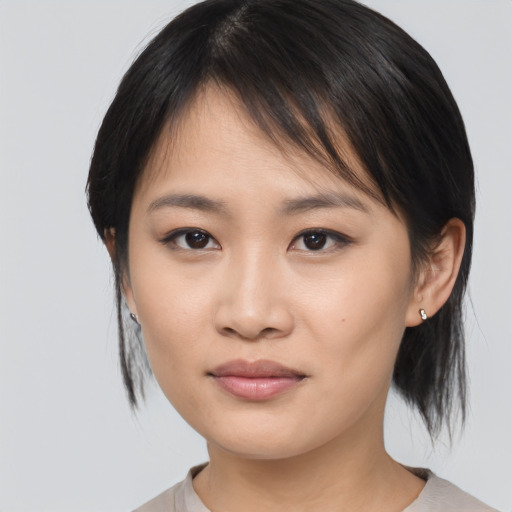 Joyful asian young-adult female with medium  brown hair and brown eyes