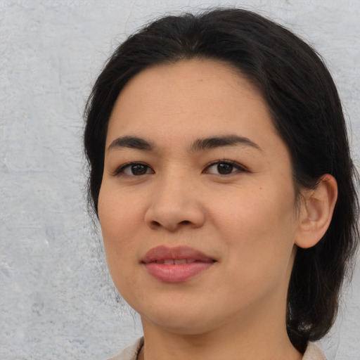 Joyful asian young-adult female with medium  black hair and brown eyes