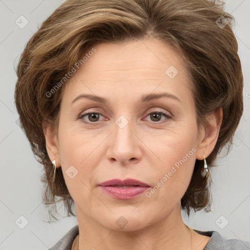 Joyful white adult female with medium  brown hair and grey eyes