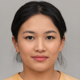 Joyful asian young-adult female with medium  black hair and brown eyes