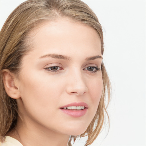 Joyful white young-adult female with long  brown hair and blue eyes