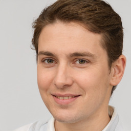 Joyful white adult male with short  brown hair and brown eyes