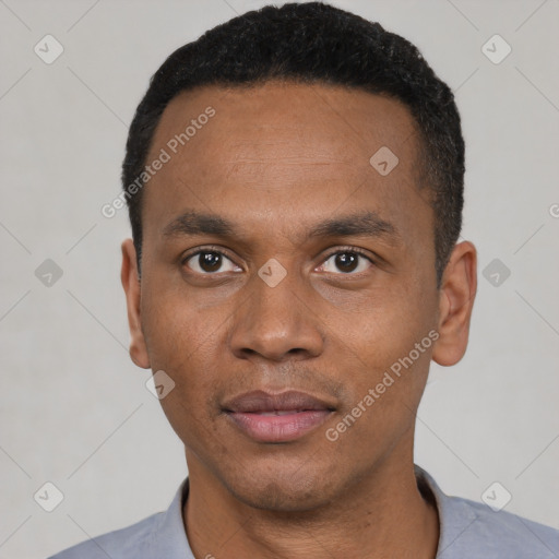 Joyful black young-adult male with short  black hair and brown eyes