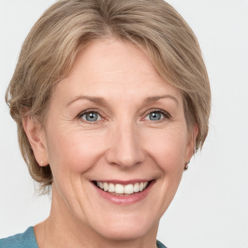 Joyful white adult female with medium  brown hair and grey eyes