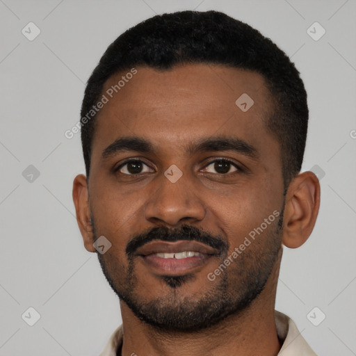 Joyful black young-adult male with short  black hair and brown eyes