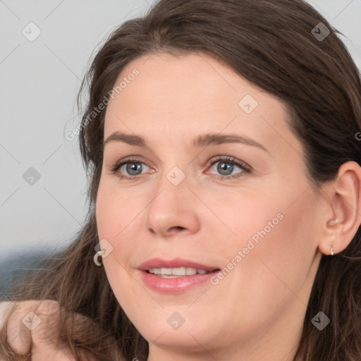 Joyful white young-adult female with long  brown hair and grey eyes