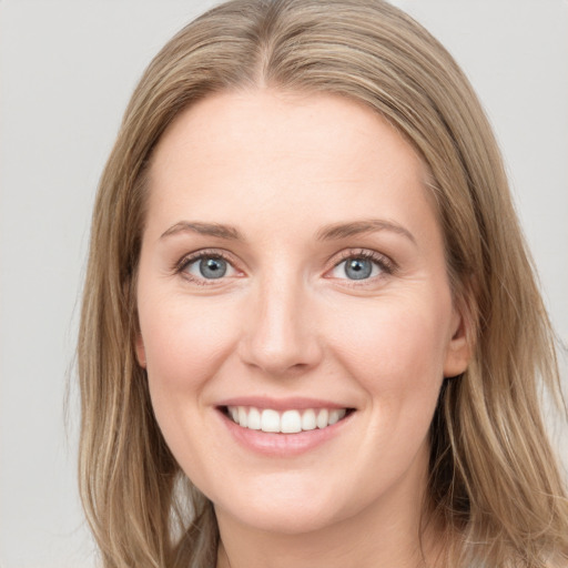 Joyful white young-adult female with long  brown hair and green eyes