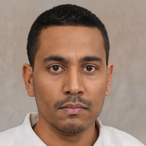 Neutral latino young-adult male with short  black hair and brown eyes