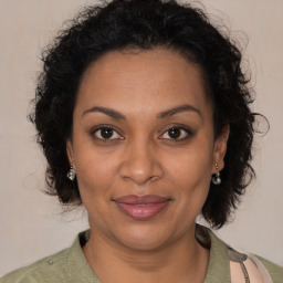 Joyful black adult female with short  brown hair and brown eyes