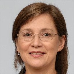 Joyful white adult female with medium  brown hair and grey eyes