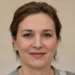 Joyful white adult female with medium  brown hair and brown eyes