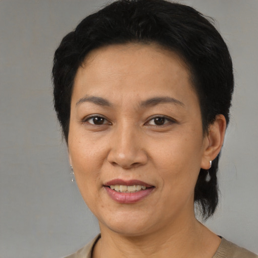 Joyful asian adult female with short  brown hair and brown eyes