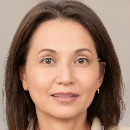 Joyful white adult female with medium  brown hair and brown eyes