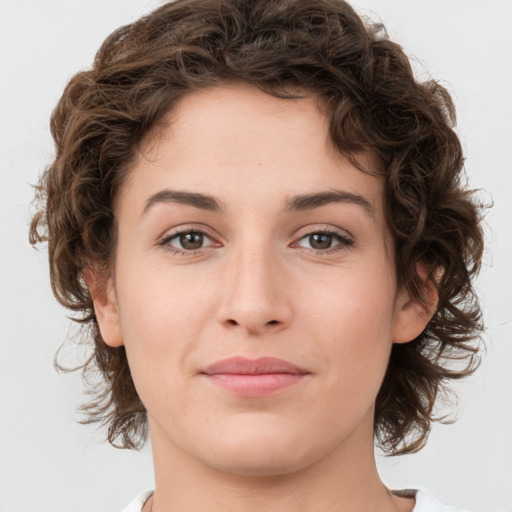 Joyful white young-adult female with medium  brown hair and green eyes