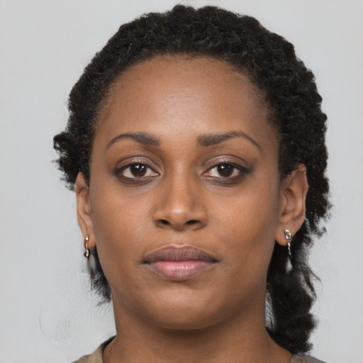 Neutral black young-adult female with long  brown hair and brown eyes