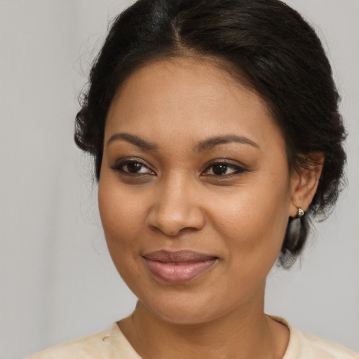 Joyful black young-adult female with medium  brown hair and brown eyes