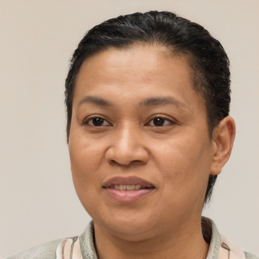 Joyful latino adult female with short  brown hair and brown eyes