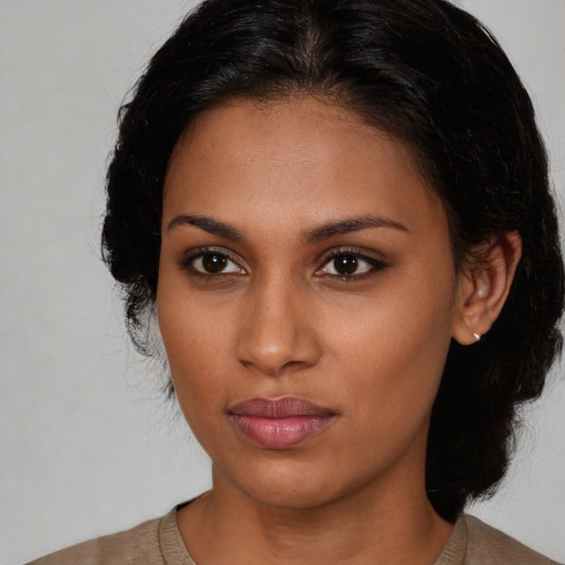 Neutral black young-adult female with medium  brown hair and brown eyes