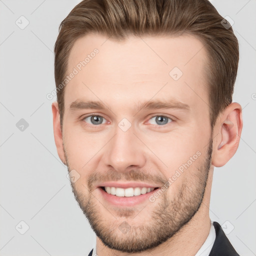 Joyful white young-adult male with short  brown hair and grey eyes