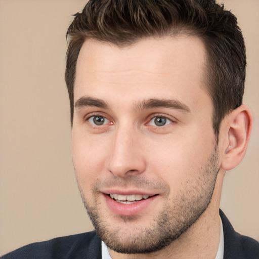 Joyful white young-adult male with short  brown hair and brown eyes