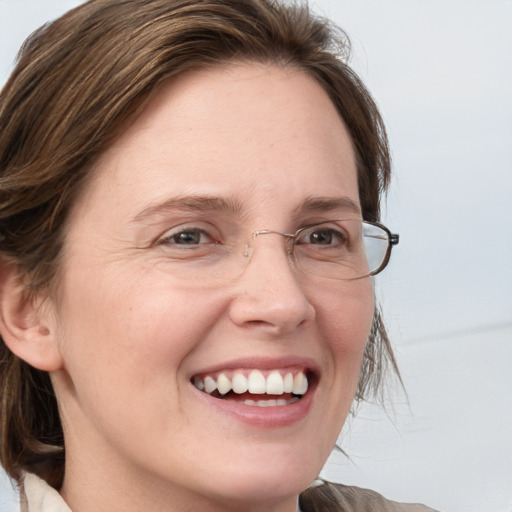 Joyful white adult female with medium  brown hair and blue eyes