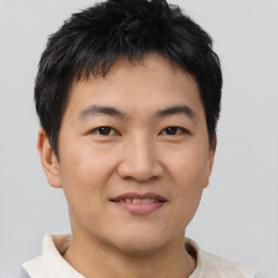 Joyful asian young-adult male with short  brown hair and brown eyes