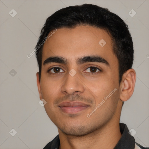 Joyful latino young-adult male with short  black hair and brown eyes