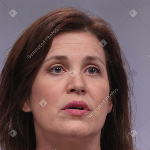 Joyful white adult female with long  brown hair and brown eyes