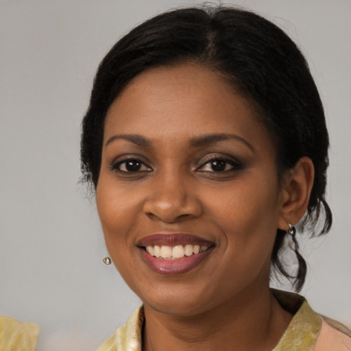 Joyful black young-adult female with medium  brown hair and brown eyes