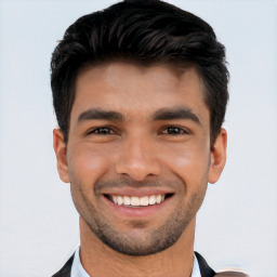 Joyful white young-adult male with short  black hair and brown eyes