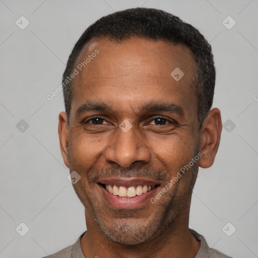 Joyful latino adult male with short  black hair and brown eyes